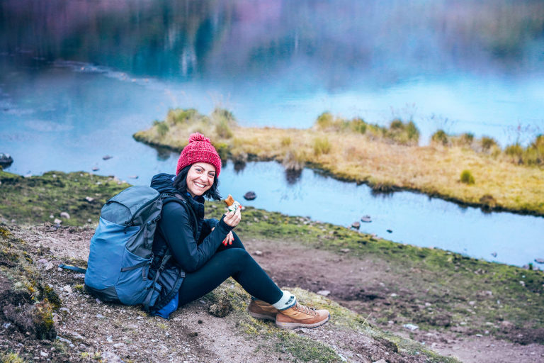 Dani sitting down near the lagoon at our first camp site to enjoy a quick snack and catch her breath.