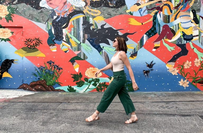 Walking in front of one of Wynwood's colorful murals