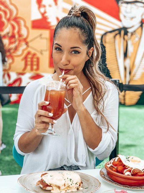 Alex taking a sip of her Michelada cocktail