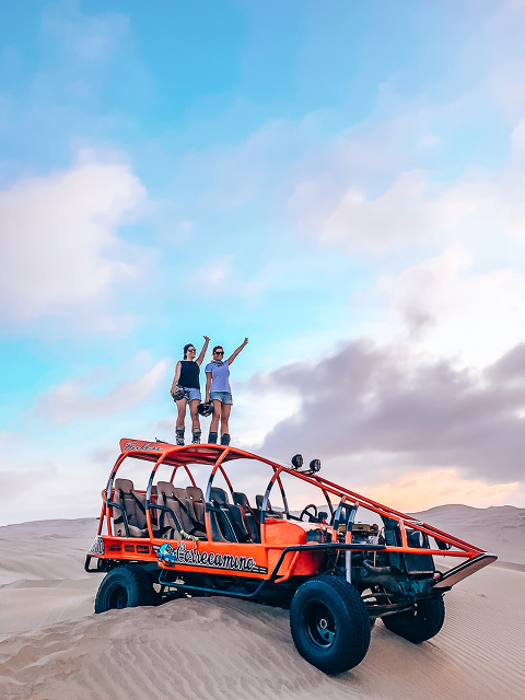 Ashley & Dani standing on top of the Sand Buggy